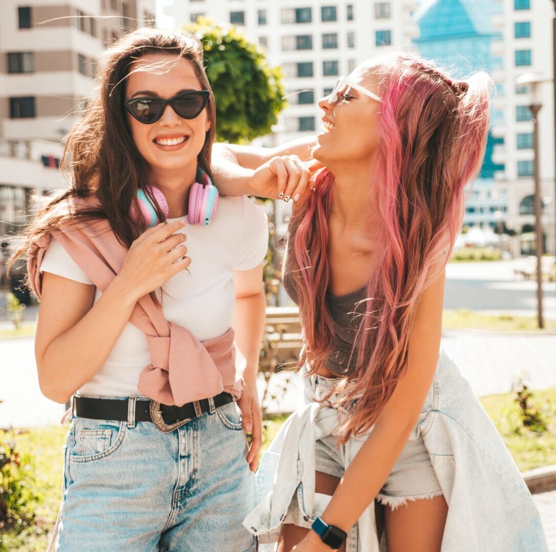 Two beautiful women posing outdoors